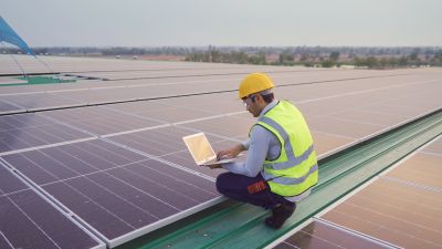 Technician Repairing Solar Panel